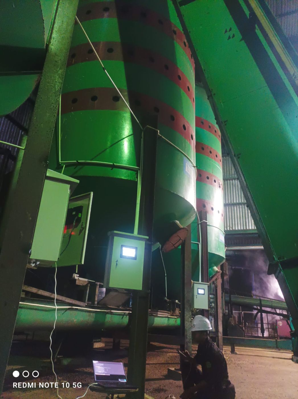 Panels with HMI screens at the silo legs at night